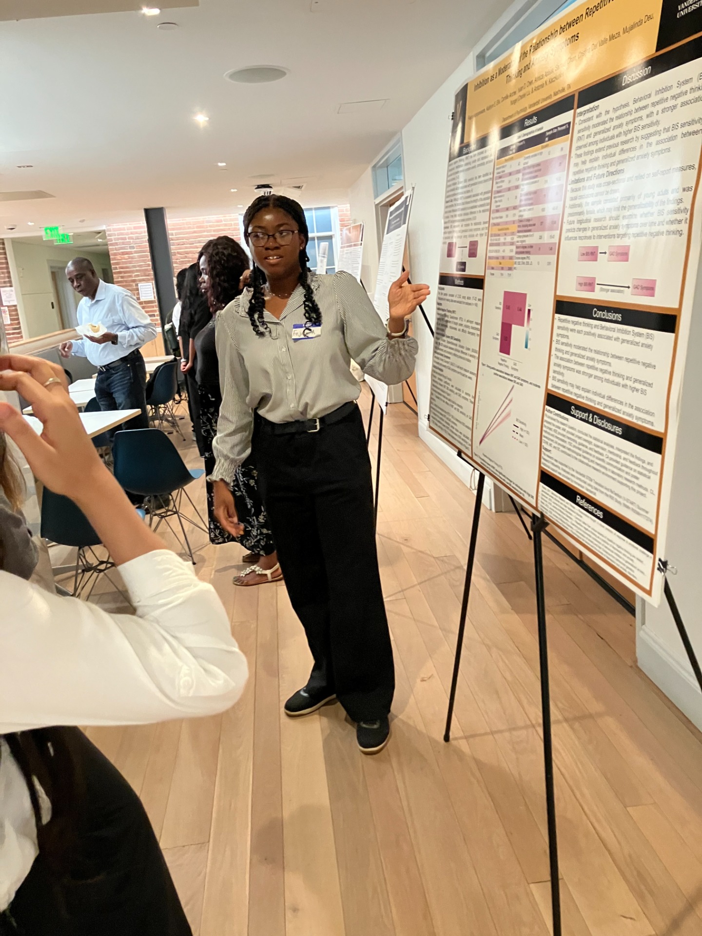 Fejiro Akpoyovware presenting her poster, "Inhibition as a Moderator of the Relationship between Repetitive Negative Thinking and Anxiety Symptoms."