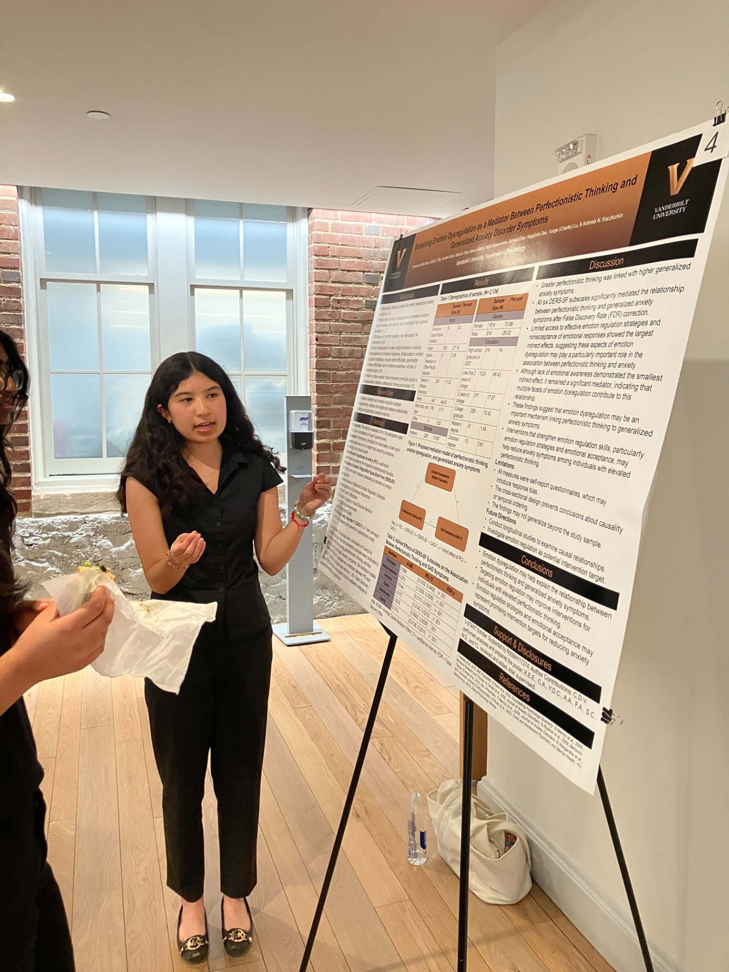 Cristina Del Valle presenting her poster, "Examining Emotion Dysregulation as a Mediator Between Perfectionistic Thinking and Generalized Anxiety Disorder Symptoms."
